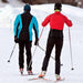 Two cross country skiers moving away from the camera. Skier on the right  is wearing  a red jacket and black ski pants and the other is in a blue and black jacket with black snow pants.  Wearing the Phonak Stick 'n' Stay Hearing Aid Stickers (30 pair) 098-0353 Phonak 