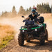 Serenity Choice Reusable Hearing Protection for MOTORSPORTS Earplugs  are used under the helmet while two people ride a quad down a dusty gravel road. 