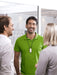 Phonak Roger Neckloop Universal Receiver 056-4005-P5111 used in the workplace.  Man in a green shirt wears the Phonak Roger Neckloop around his  neck while speaking to co-workers. 