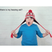  Where is my hearing aid? Use the Phonak Stick 'n' Stay Hearing Aid Stickers (30 pair. This boy in a long sleeved blue t-shirt is holding his red winter hat or toque by the tie strings as he looks up at the ceiling with his mouth open in frustration.  
