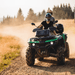 Serenity Choice Reusable Hearing Protection for MOTORSPORTS Earplugs  are used under the helmet while two people ride a quad down a dusty gravel road. 