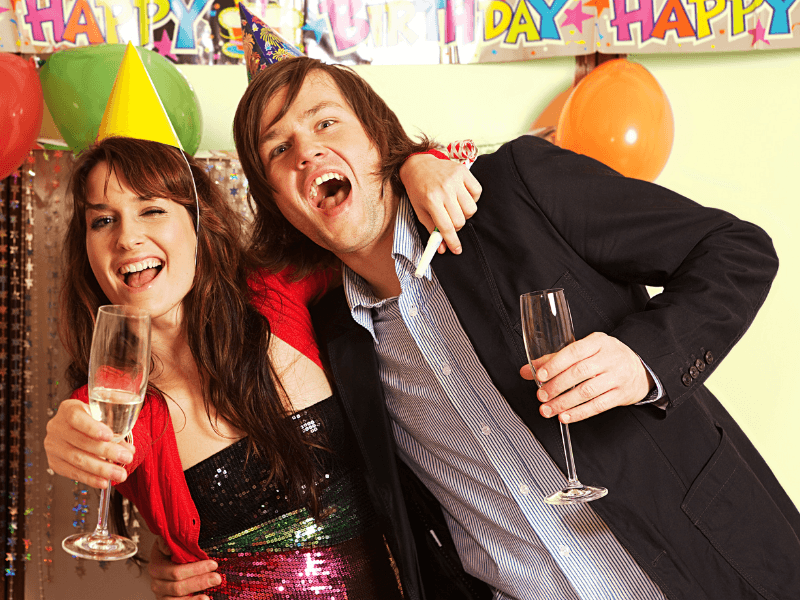 Happy Birthday party goers!  A couple celebrate with a party and drinks. Loud celebrations are no concern if you use the Serenity Choice Reusable Hearing Protection for SLEEP Earplugs. 